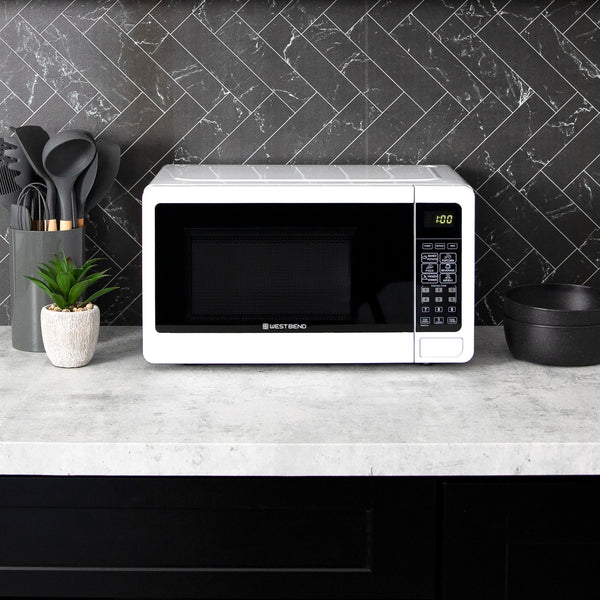 0.7 cu. ft. microwave oven on kitchen counter with dark front and right keypad