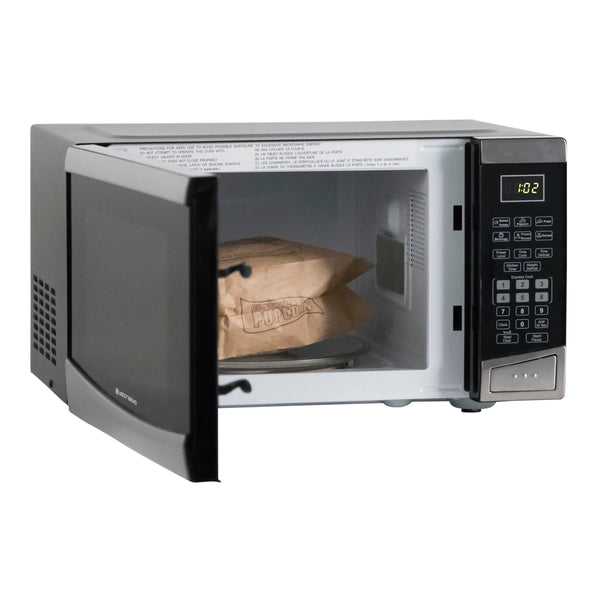 White microwave oven with door open and paper bag inside