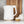 White electric kettle with gold base trim and side handle on countertop