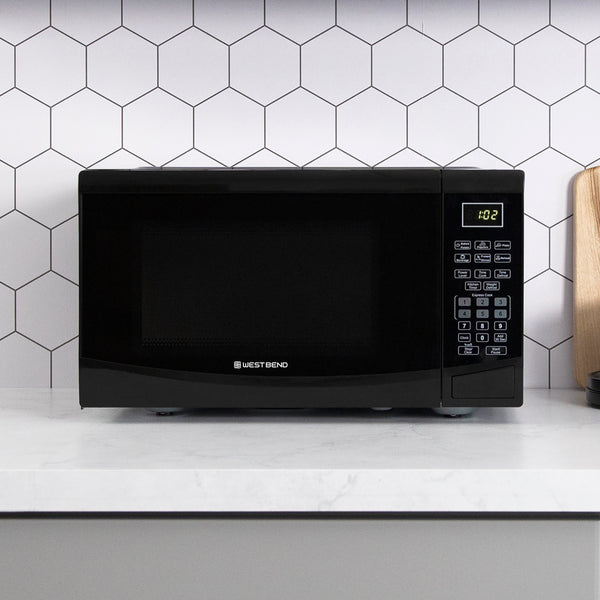 Black microwave oven front view on countertop with control keypad
