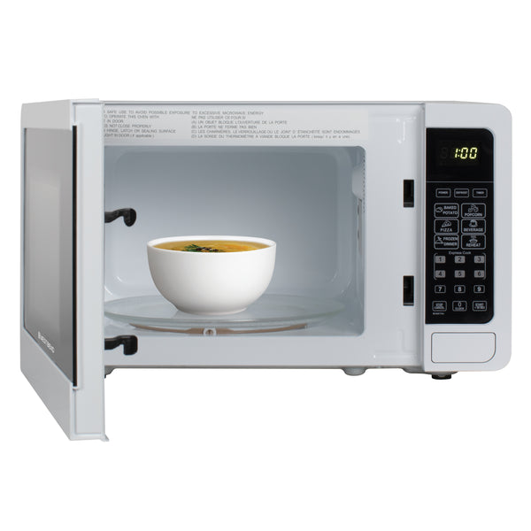 0.7 cu. ft. microwave oven door open with cup and plate inside
