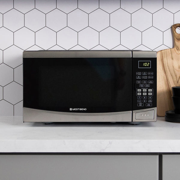 Black microwave oven front view on counter with keypad and handle