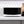 Black microwave oven front view with keypad and countertop setting