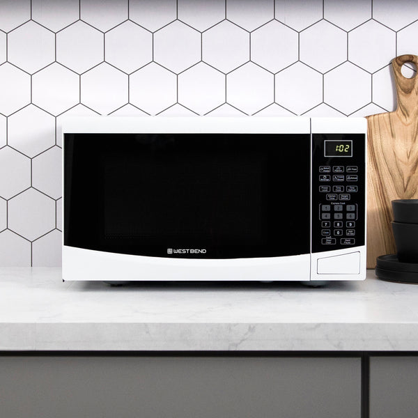 Black microwave oven front view with keypad and countertop setting