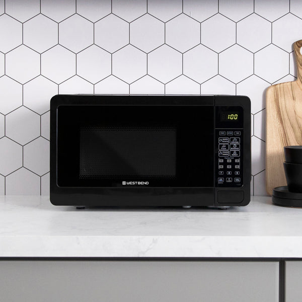 0.7 cu. ft. microwave oven with black window and lit display on right
