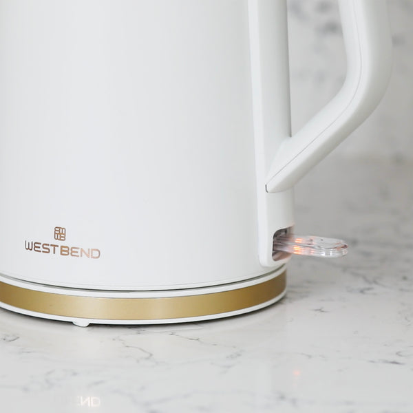 White electric kettle close-up of handle and base indicator light